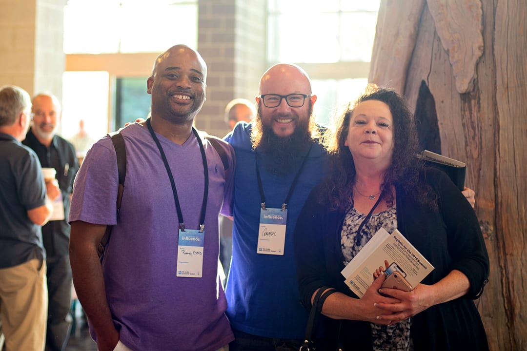 Three GLS18 attendees smile while enjoying the conference.